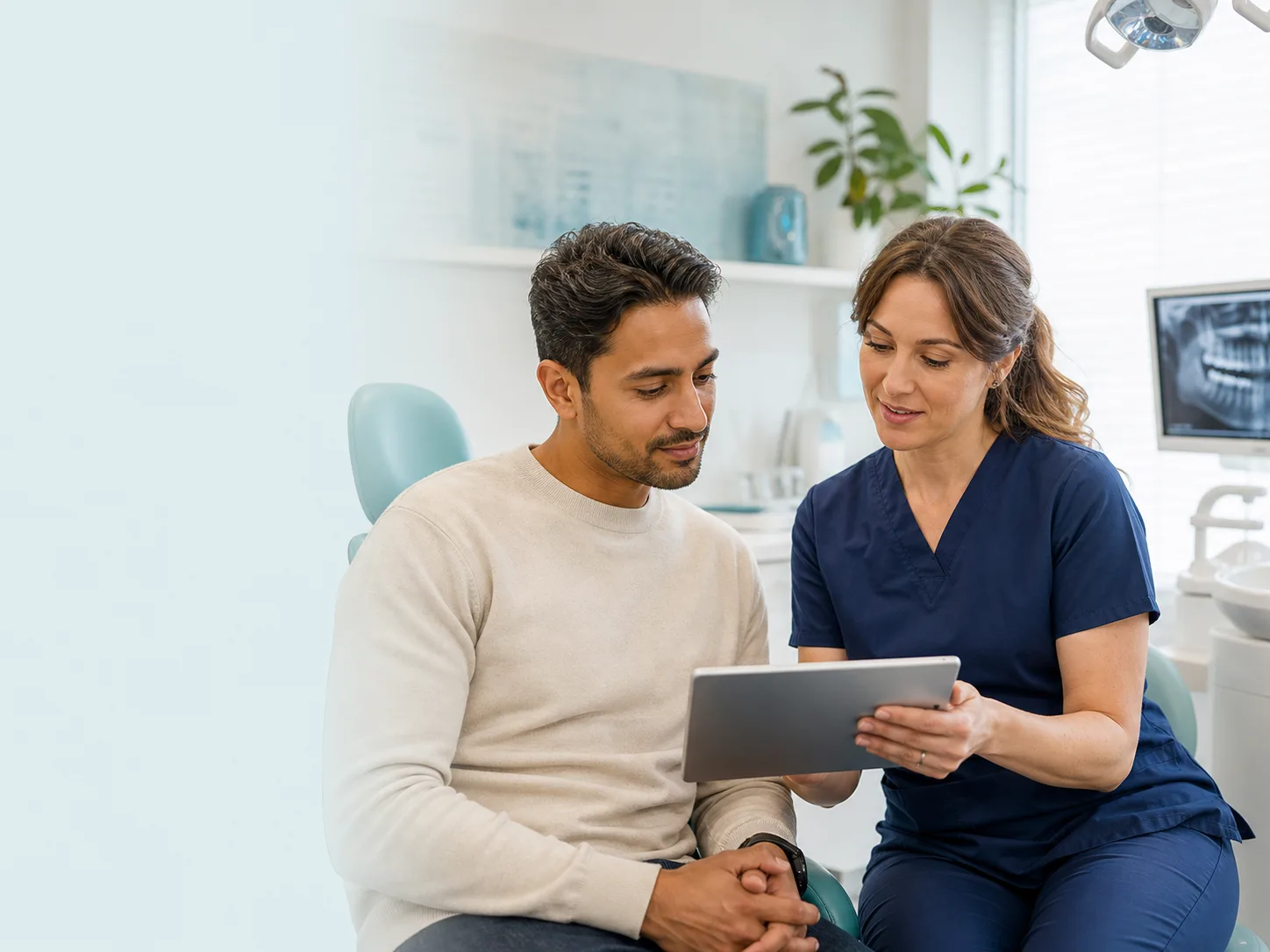 A patient discusses a treatment proposal with a dental professional in the clinic.